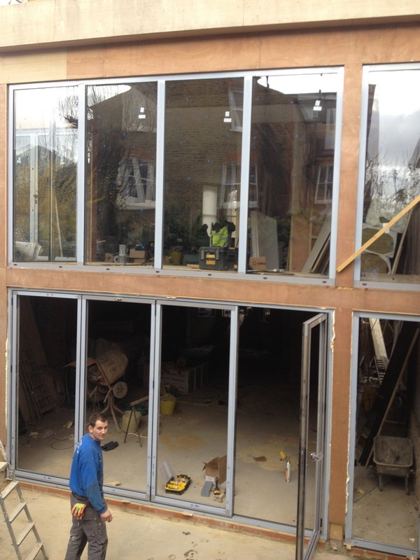 Aluminium bi-fold doors with two-storey glazing in Banstead