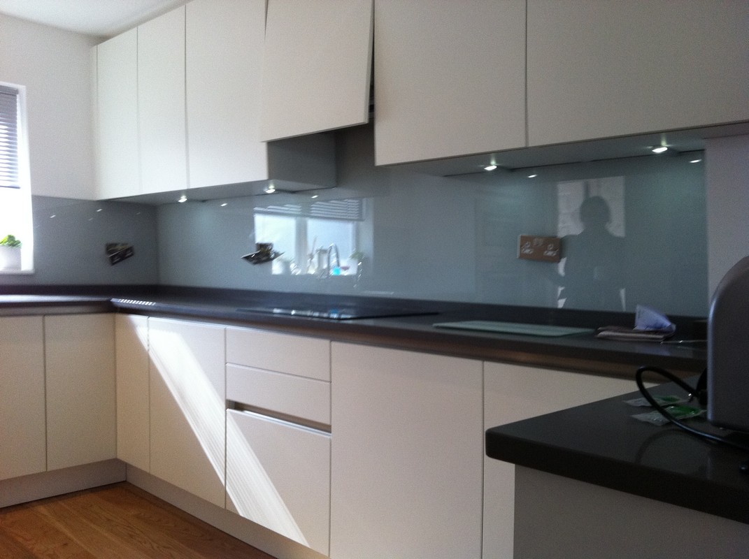 Grey glass kitchen splashback with LED lighting in Banstead